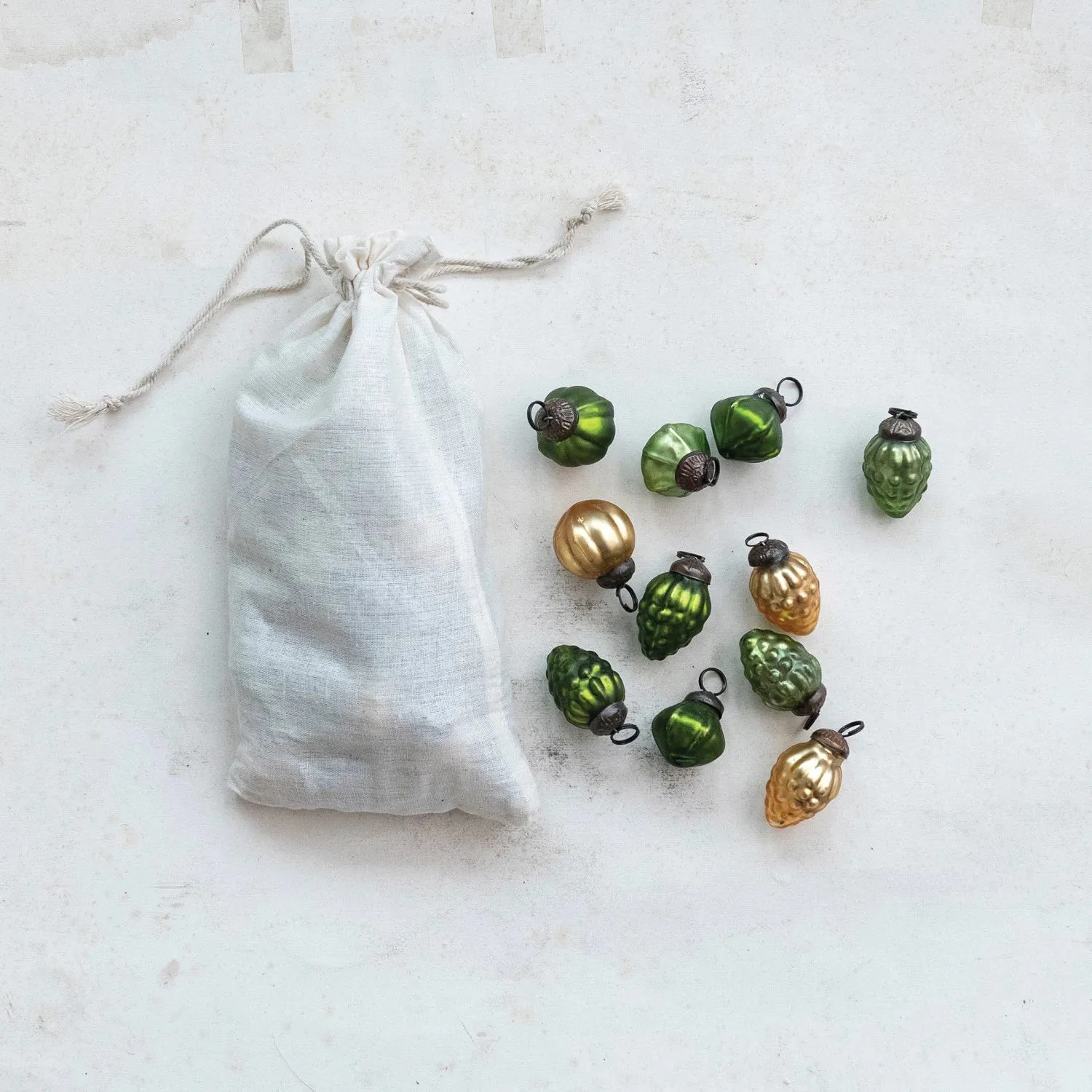 GREEN AND GOLD ORANEMNTS IN MUSLIN BAG